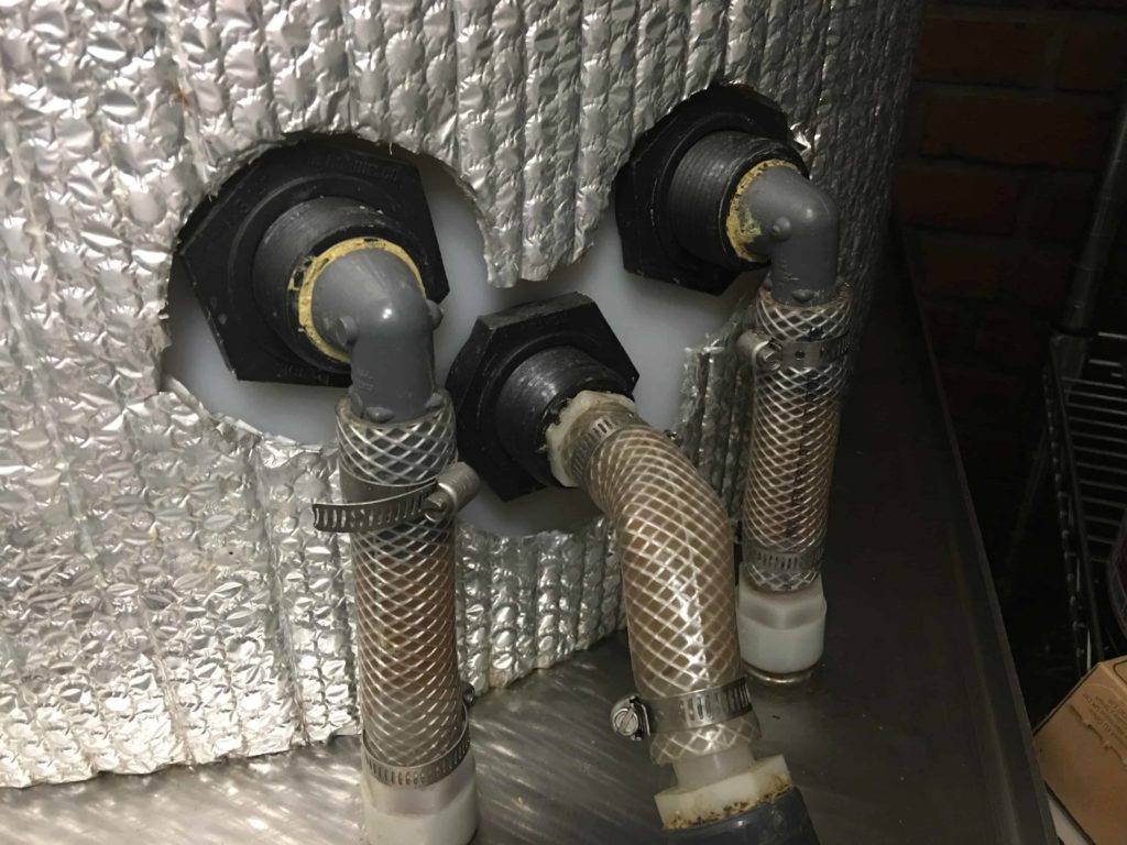 Diana purchased a lot of premium hardware to open her shop. These are connectors to MilkMade's pasteurizer water cooler. It is a big vat of water that rapidly cools the pasteurized ice cream base.