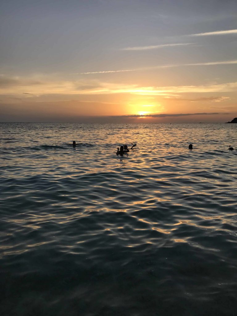 Beautiful colors including orange, blue, and deep blue with small waves in the water