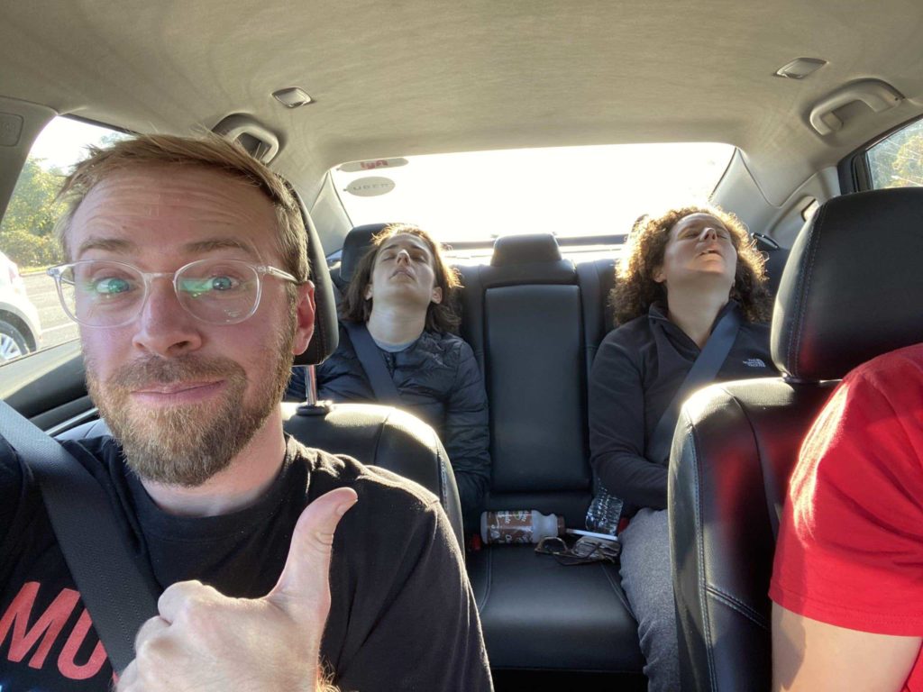 Two women asleep in the back of a car