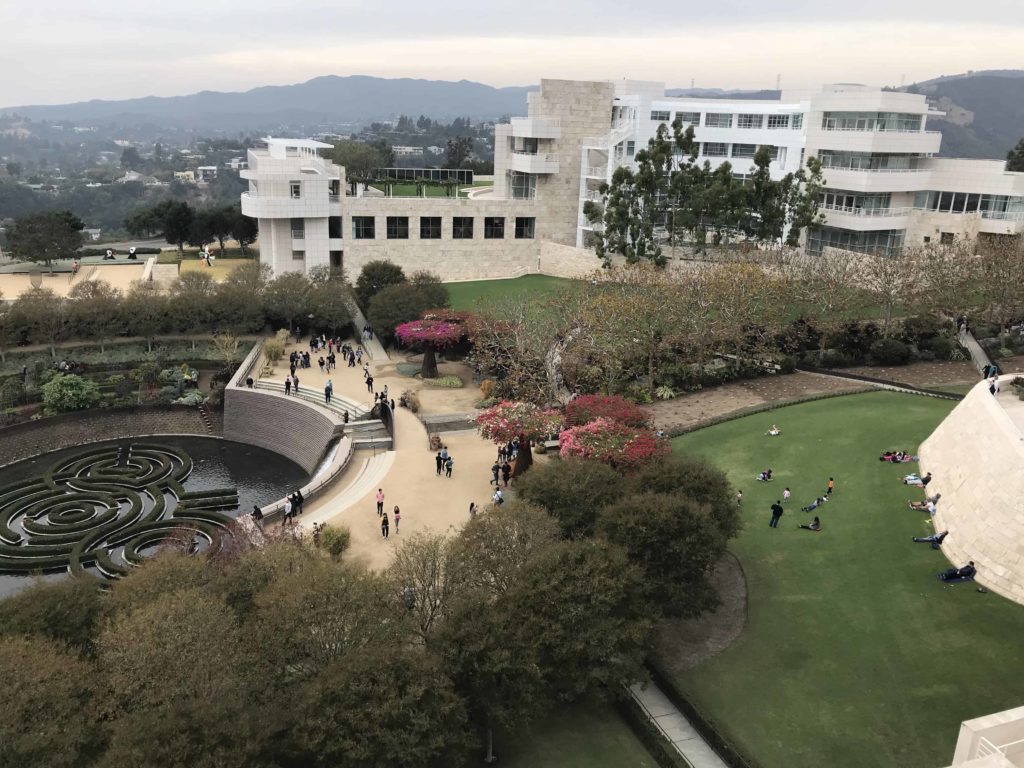 Green grass below and white buildings