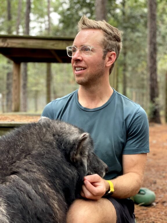 a wolfdog getting close with a man