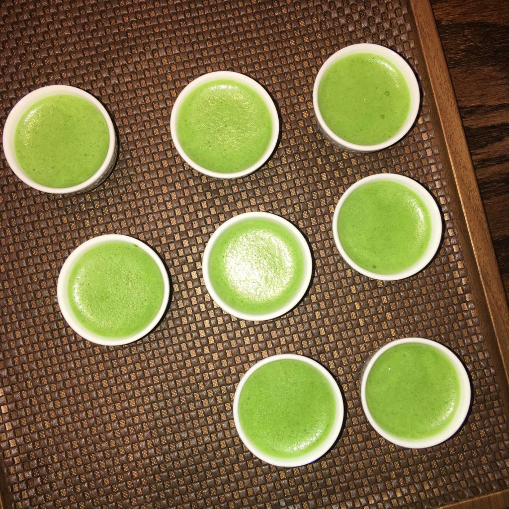 Many shots of matcha poured, ready to be served to the class.