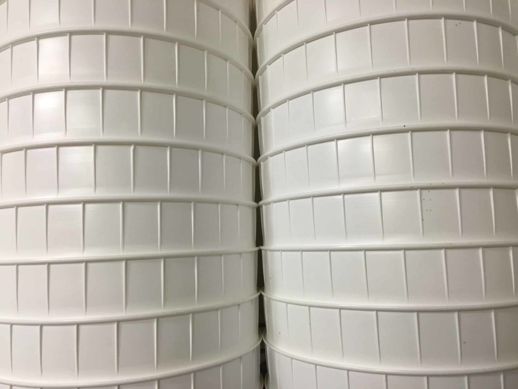 Collection of large white containers in the storage room.