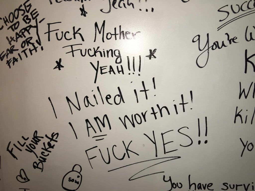 Customers signed this wall after they completed an intensive workout program