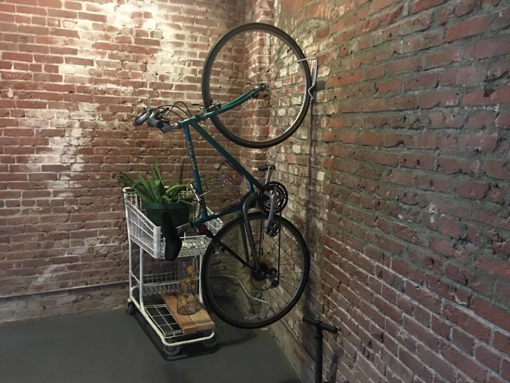 Bike hanging on a wall in Podshare LA