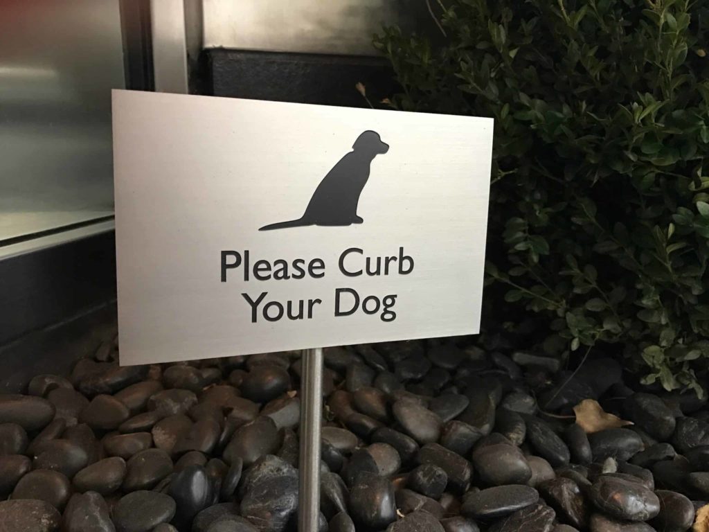 Sign that says Please Curb Your Dog