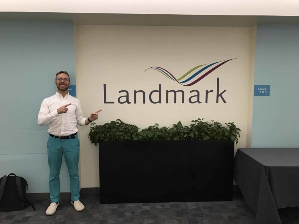 Me pointing at the Landmark logo sign at their HQ in NYC