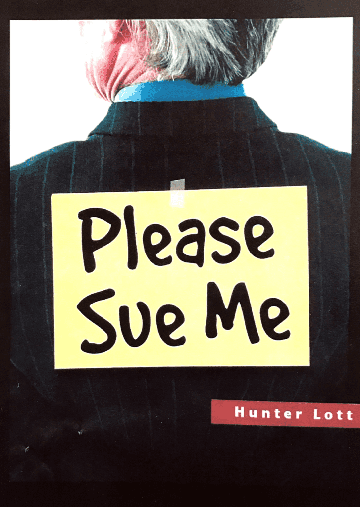 Sticker on the back of a man says "Please Sue Me"