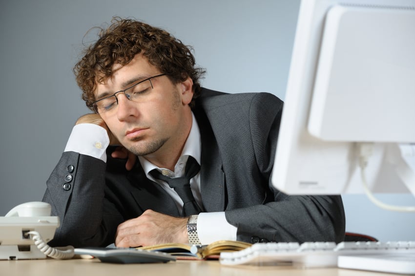Person sleeping in office at desk