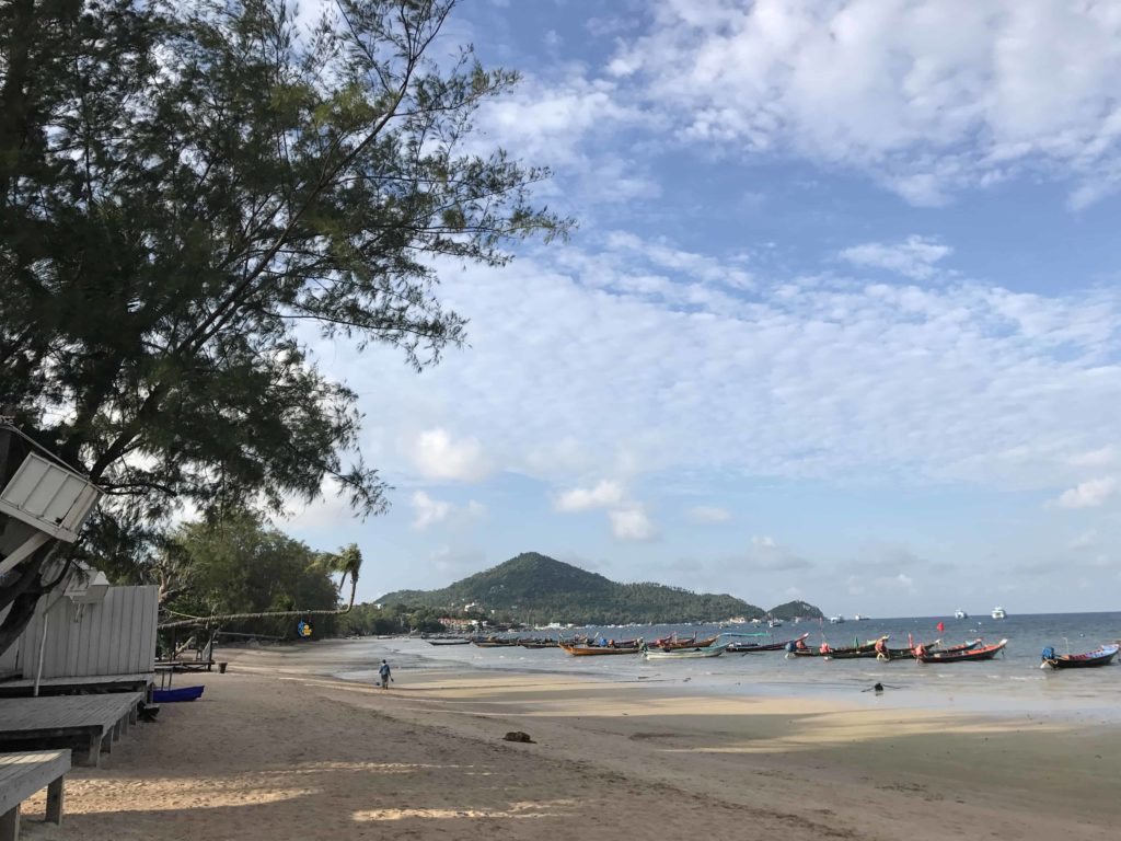 Sandy beach and green hill in background of Koh Tao, Sairee Beach