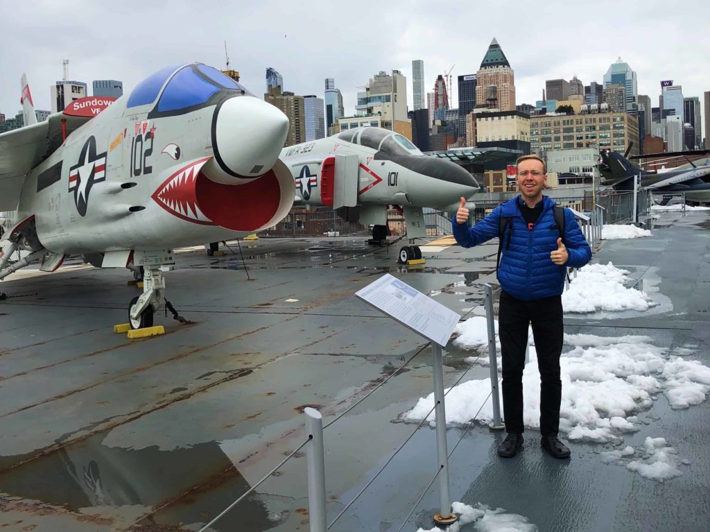 Very cool gentleman is pictured outdoors near a WWII-era jet maybe