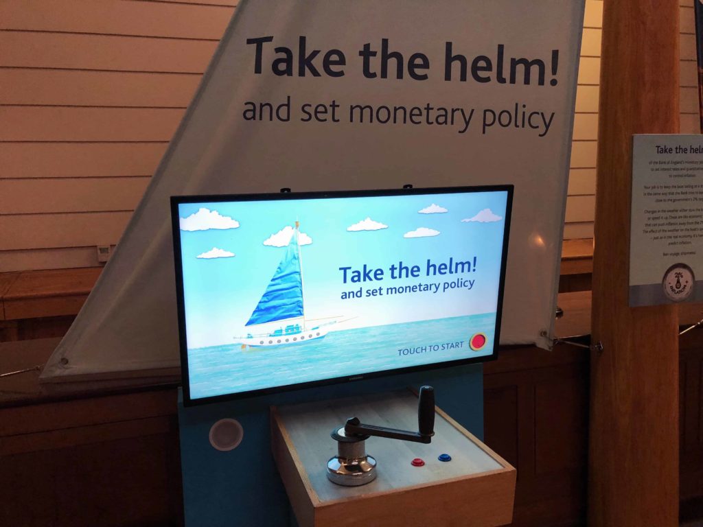 Image of a museum display at Bank of England that says Take the helm and set monetary policy