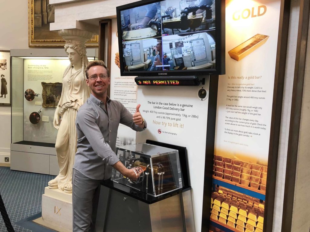 Man at the Bank of England Museum holding a gold bar, sort of