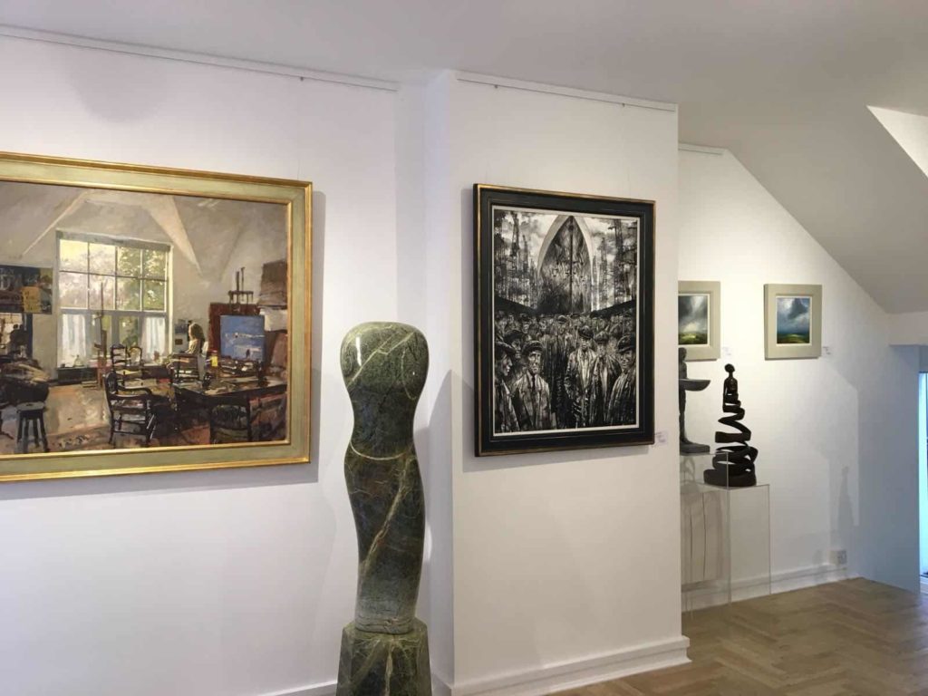 Art gallery with paintings on the wall and a sculpture