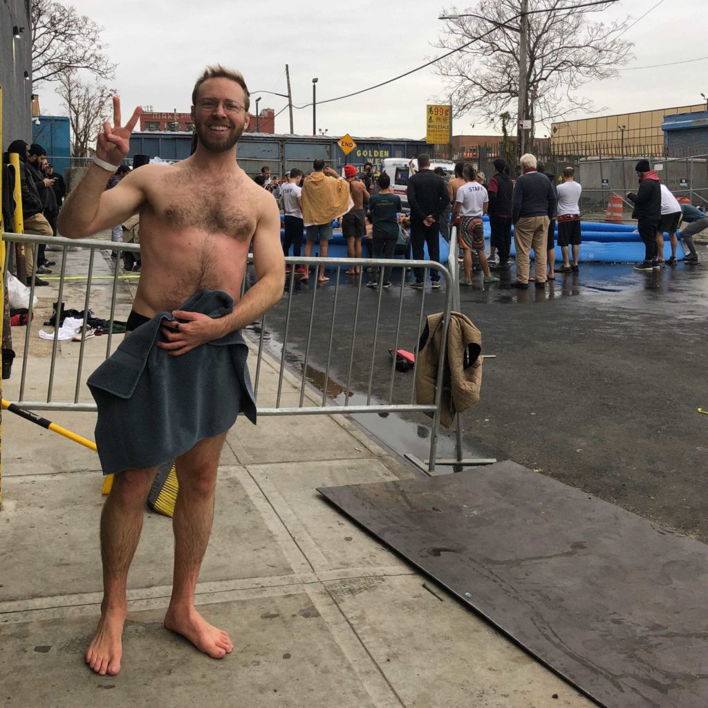 Attractive white man with barely a towel covering him at Wim Hof experience