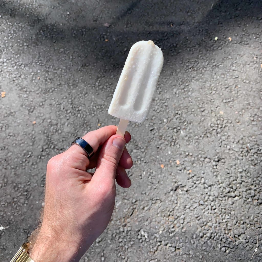 White hand holding a popsicle