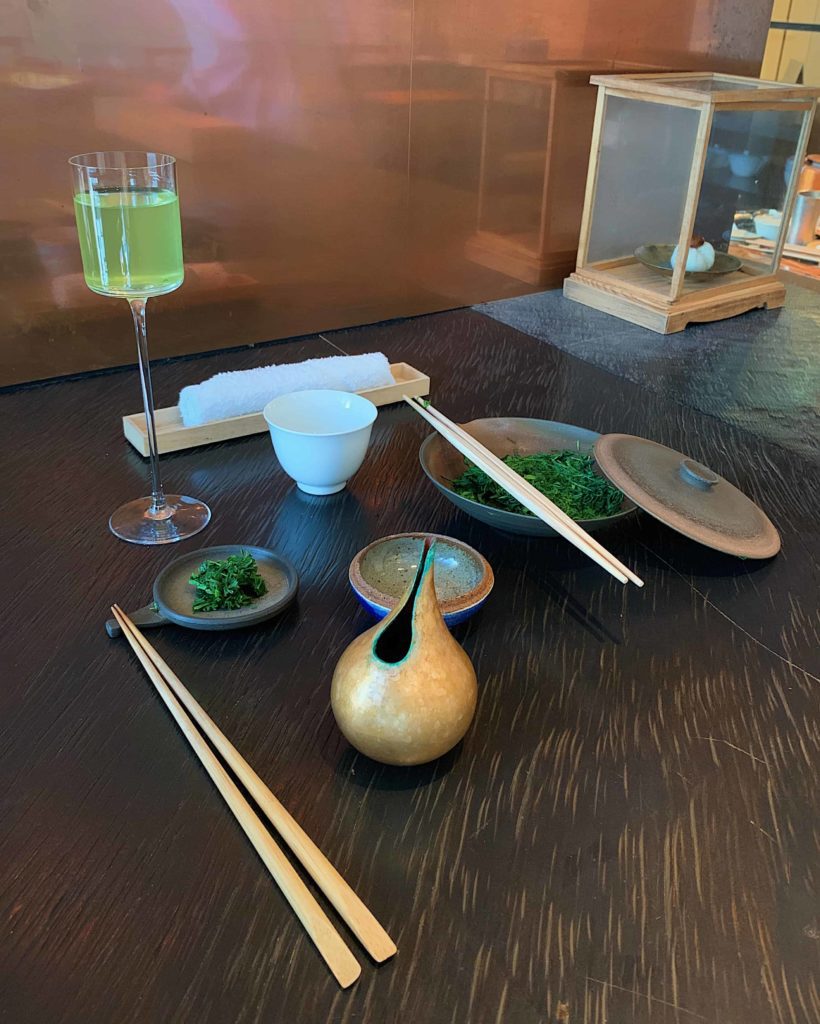 Table with green tea setup including chopsticks to eat it