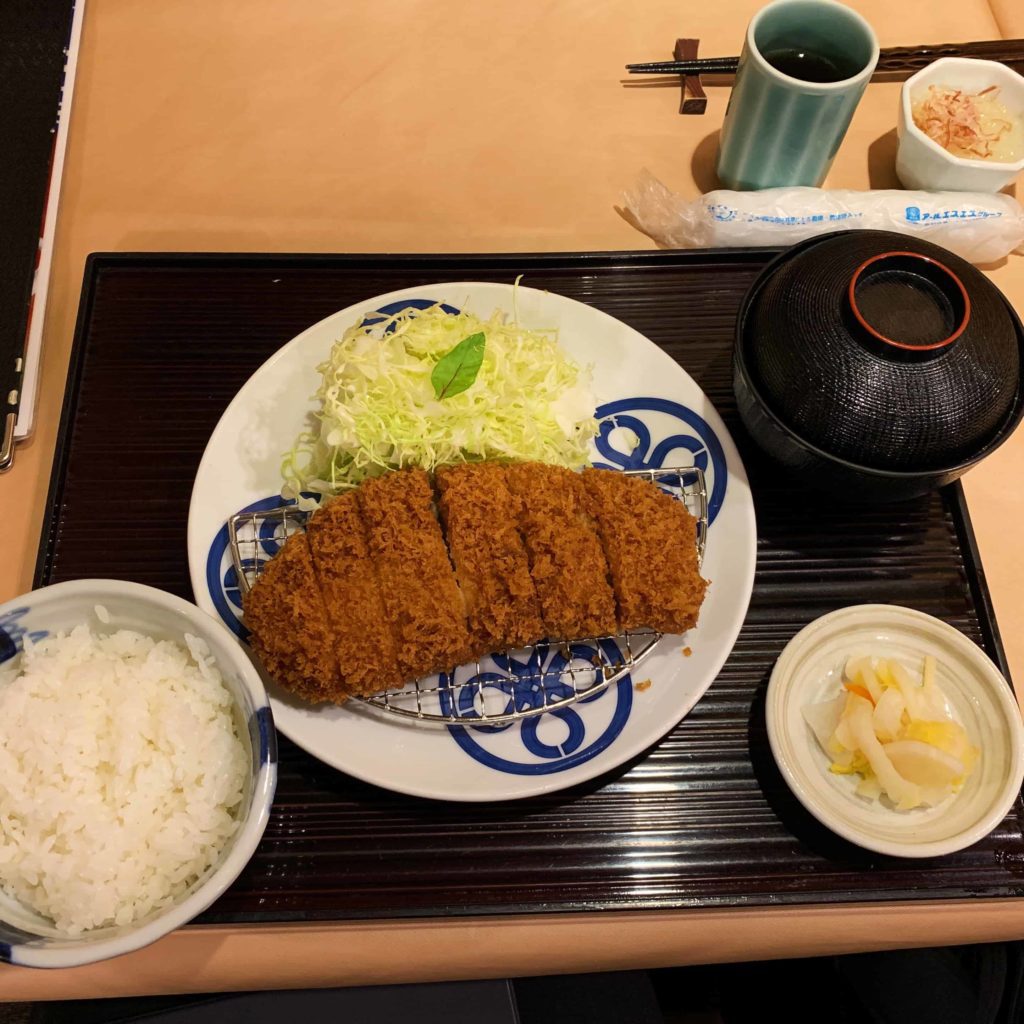 Plate of pork katsu: rice on the left, katsu in middle large place, miso soup top right
