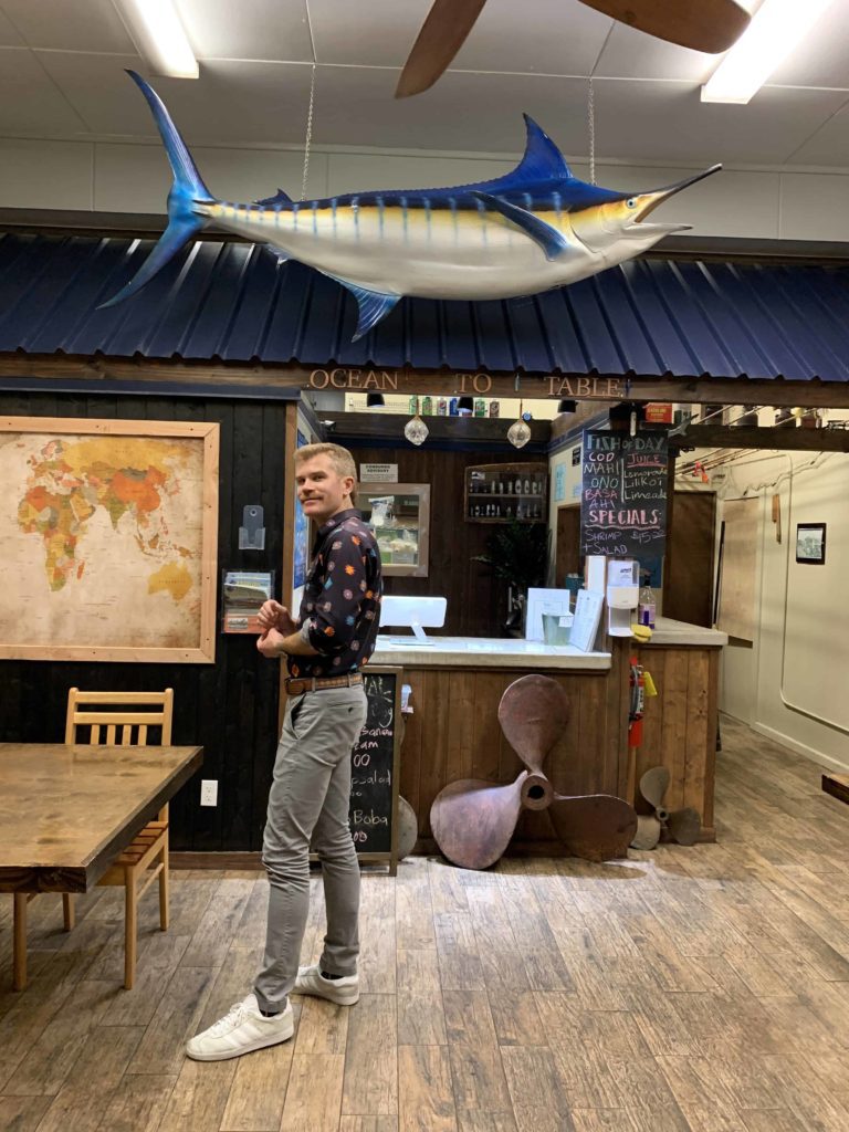 My friend Todd Iceton standing beneath a fish (fake) inside a restaurant