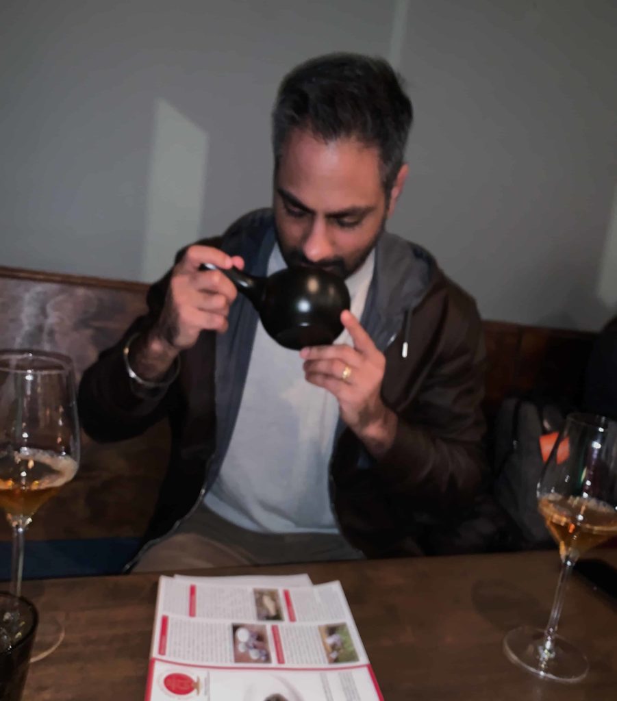 Ramit Sethi smelling a bowl of green roasted tea