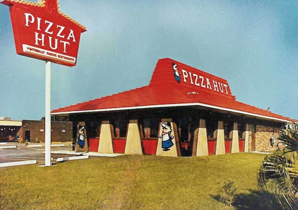 Standalone building with red roof and Pizza Hut sign outside