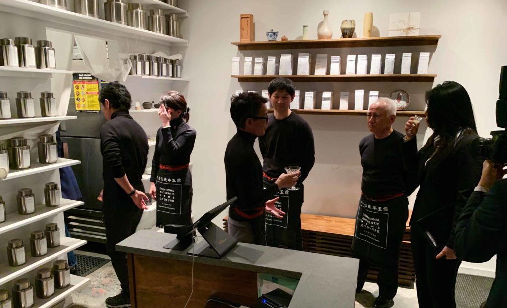 Inside 29B Teahouse, and people wearing all black standing in the lobby of the shop
