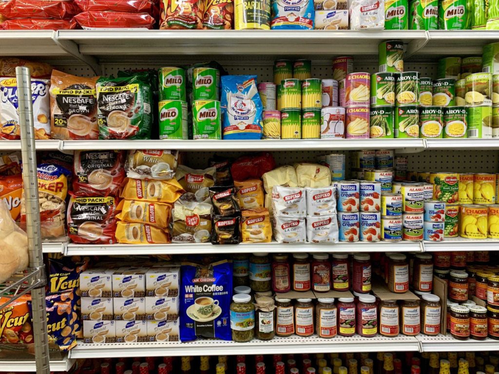 Racks of different packaged foods and snacks and some candies