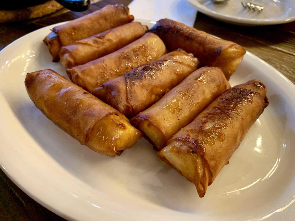 Egg roll-looking things on a white plate
