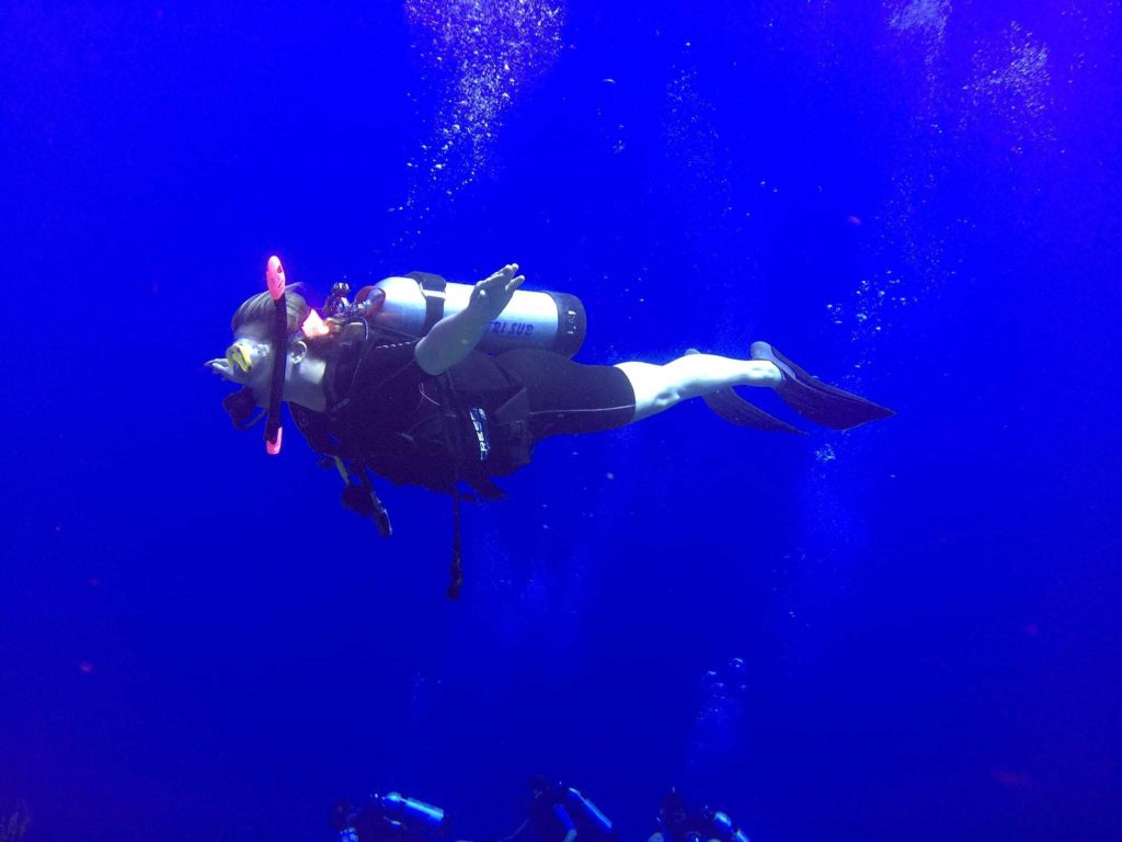 Woman SCUBA diving in Roatan