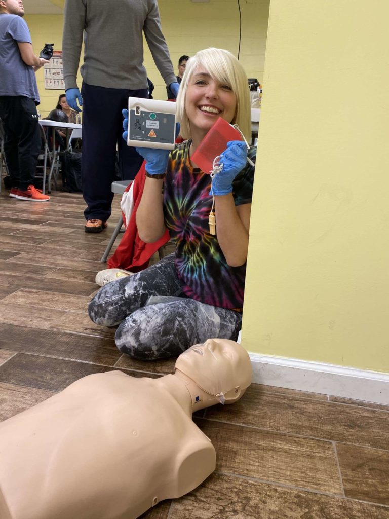 Woman holding the AED at First Aid class in NYC
