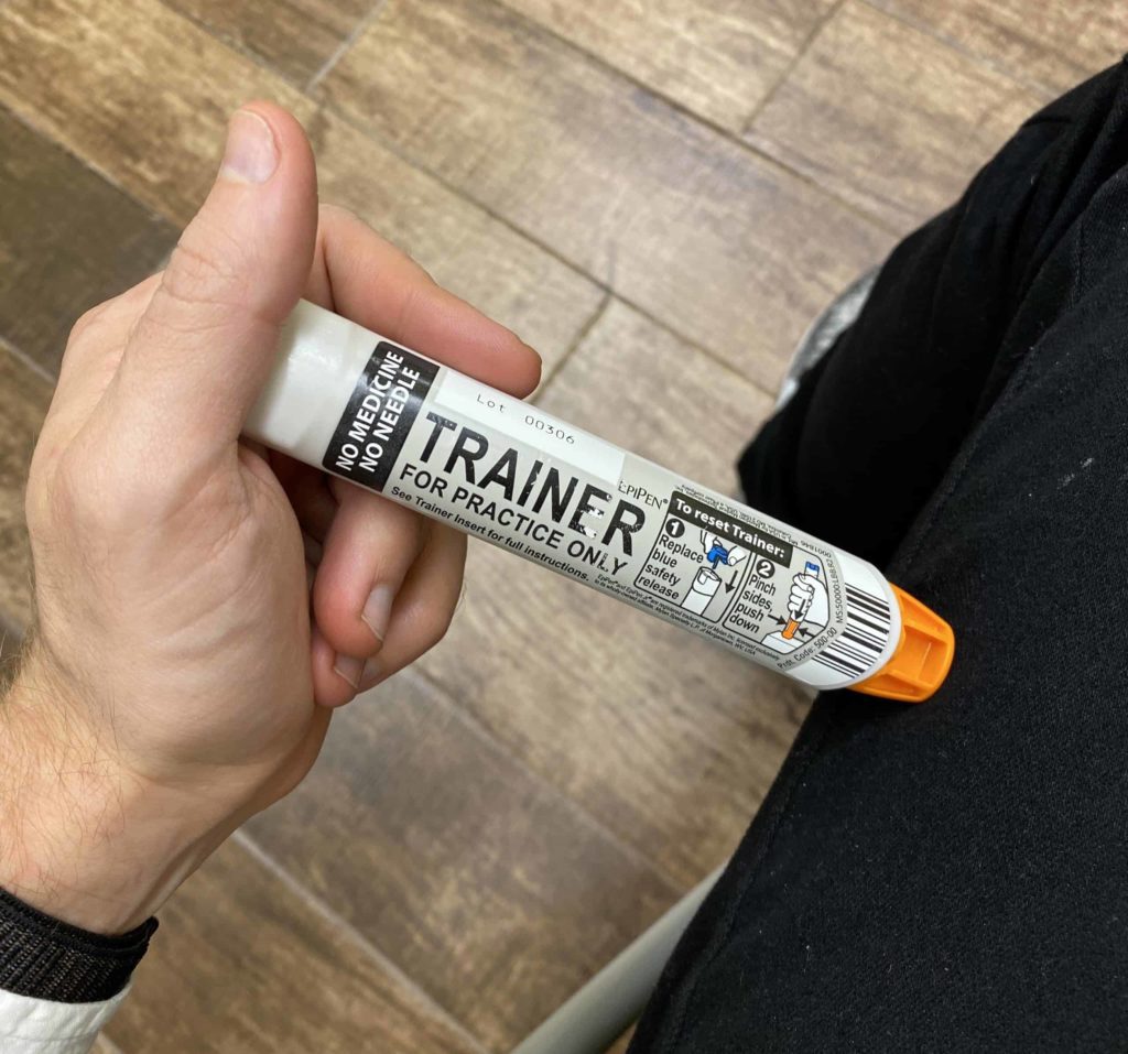 Trainer EpiPen and black jeans