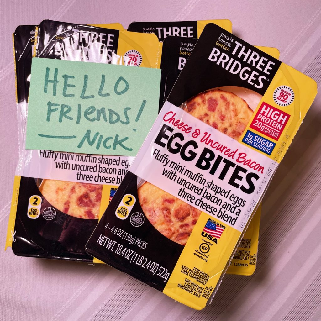 Microwave egg bites from Costco, several packages of them plus a sign saying HELLO FRIENDS