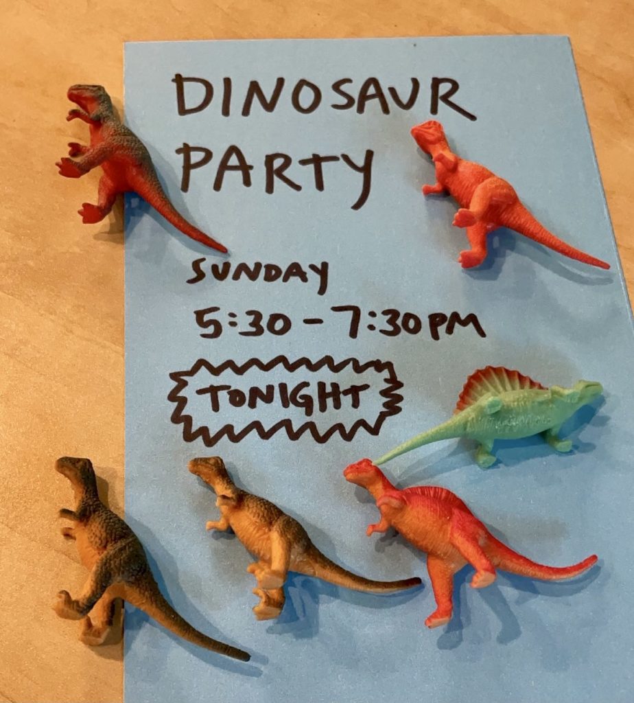 plastic toys on top of text that says Dinosaur Party Tonight