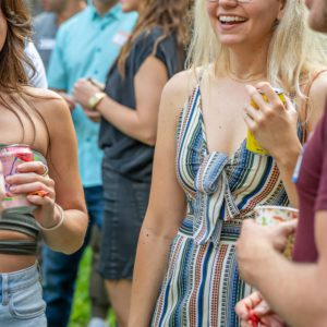 a woman named Madi Taskett standing at a party outside