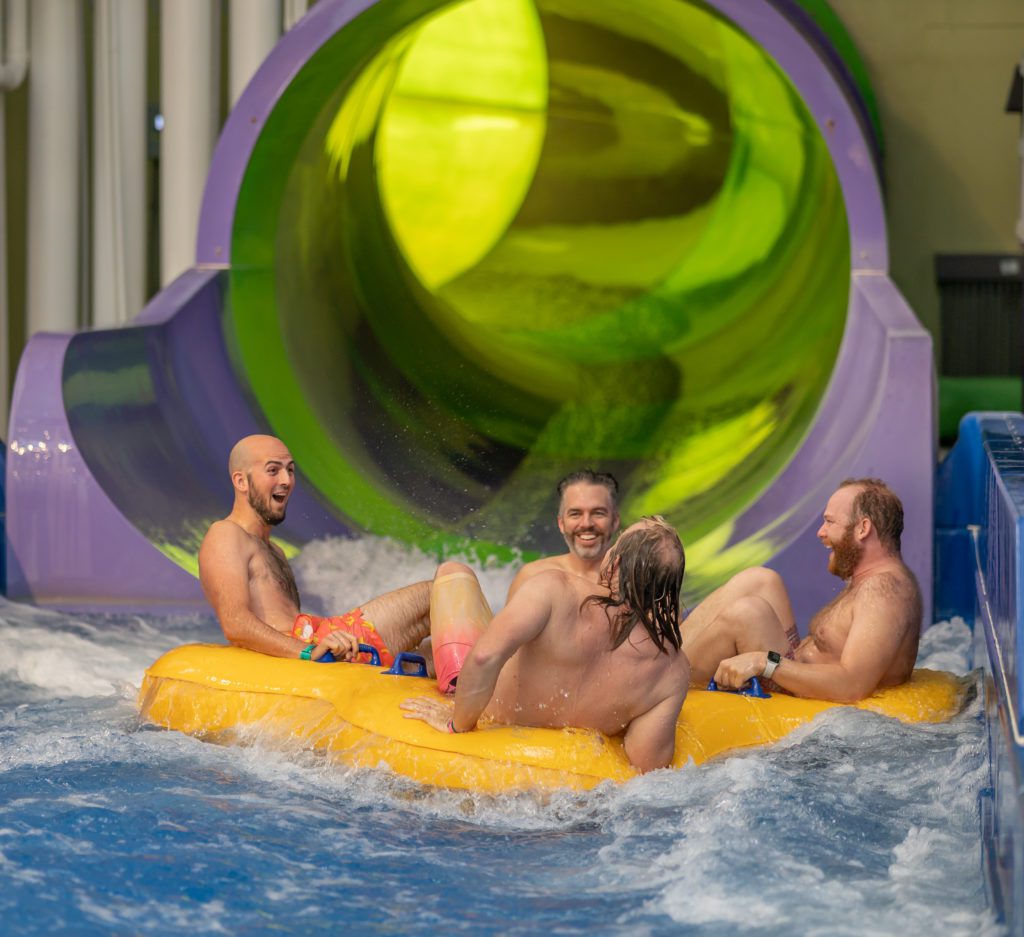 four people and a water slide at Kalahari Resorts Indoor Waterpark in Texas for Nick Gray's birthday party