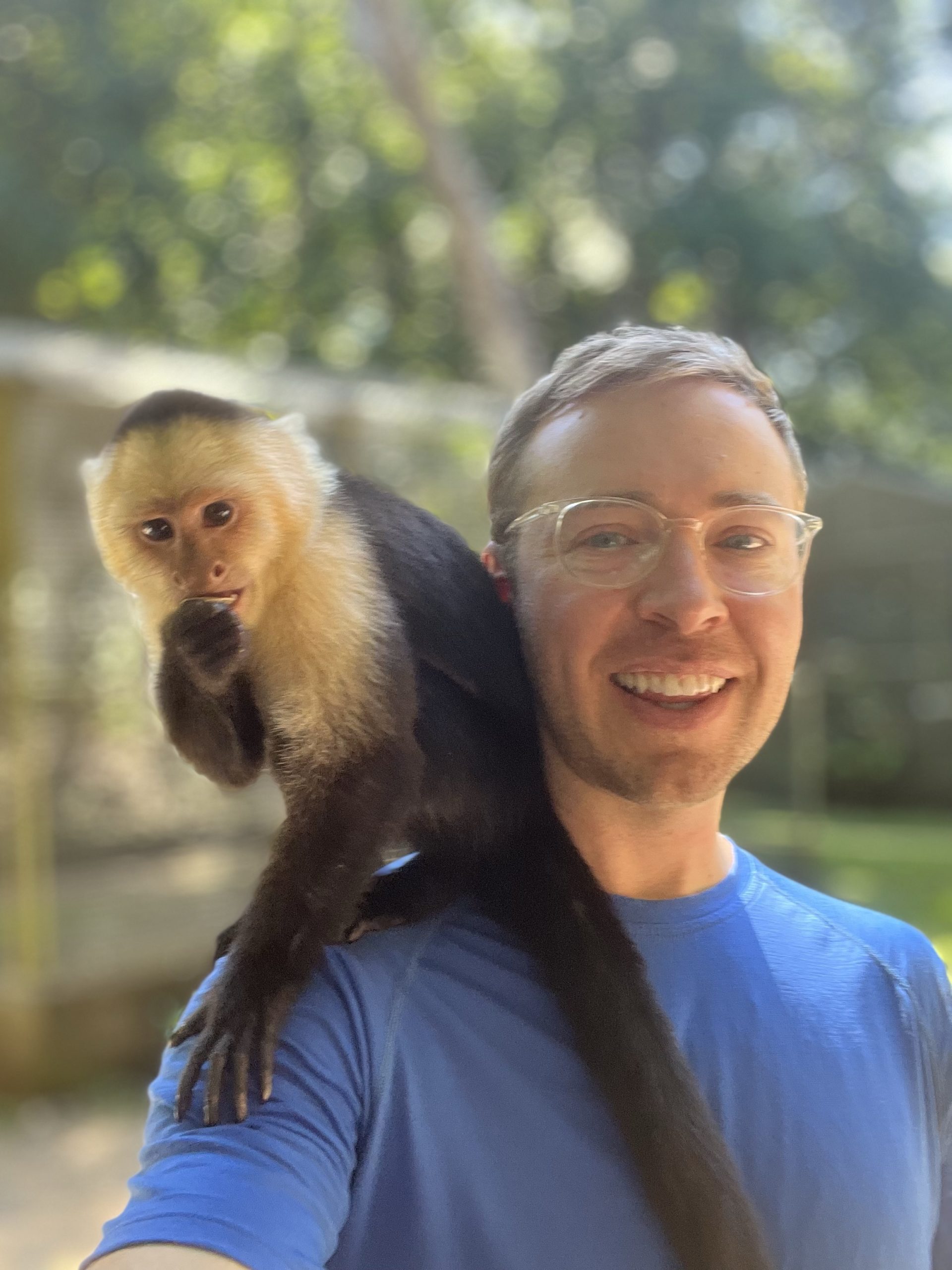 man with a Capuchin monkey on his shoulder