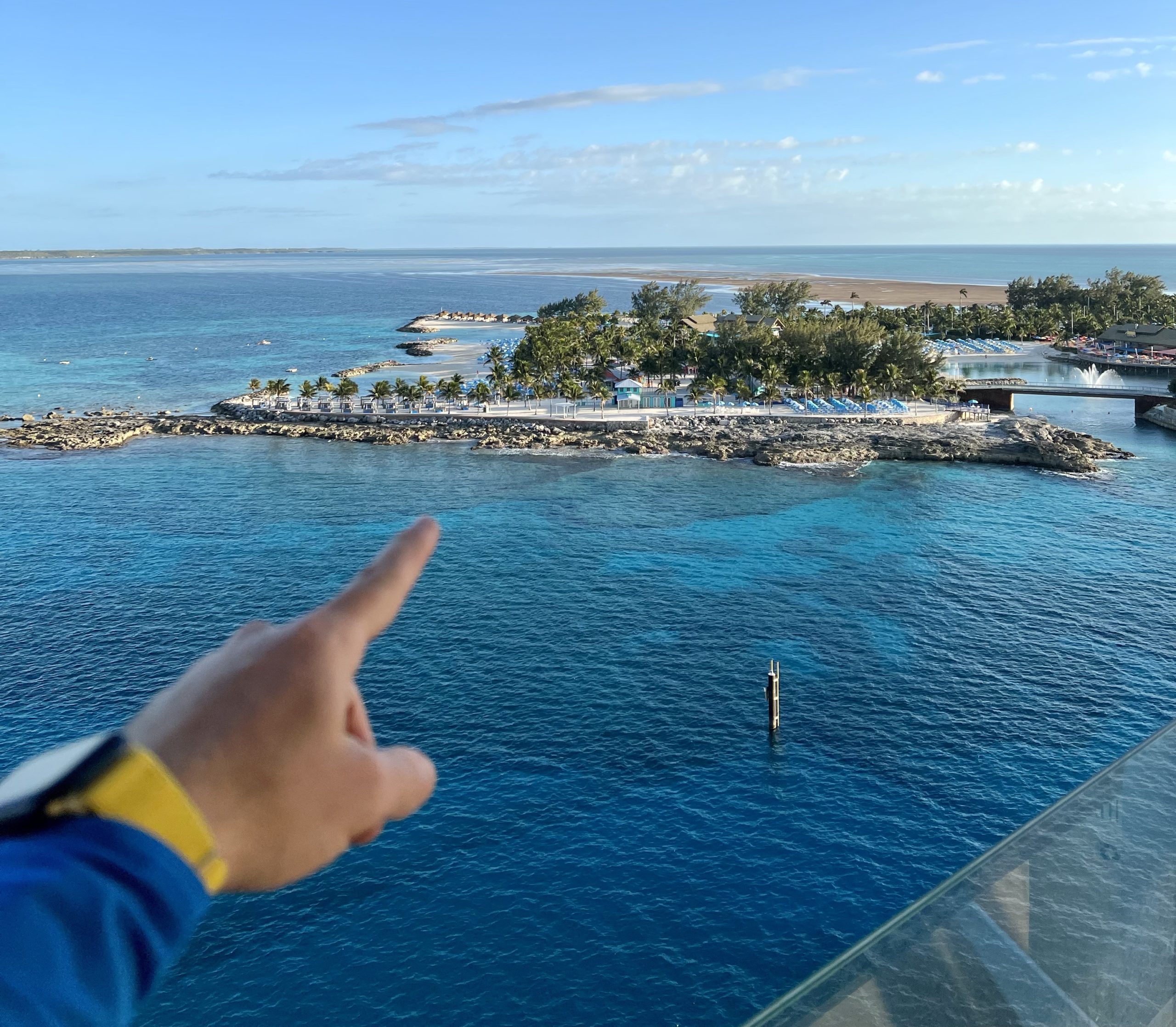 finger pointing to ocean and private island