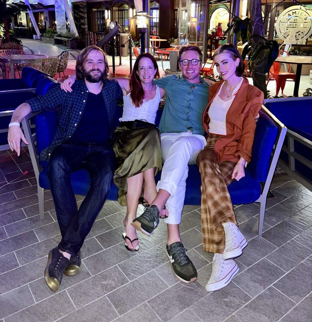 four people sitting on a sofa aboard the Symphony of the Seas cruise ship
