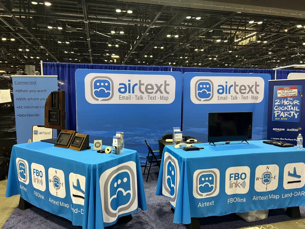 slightly larger trade show booth showing blue signs for Airtext