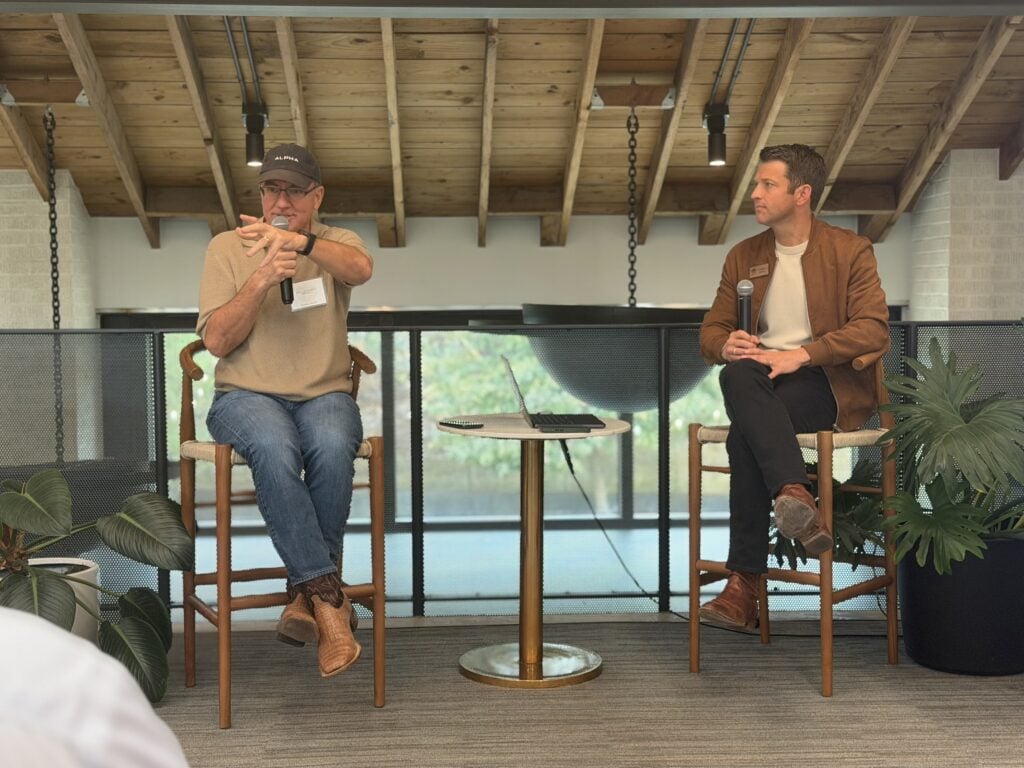 Joe Liemandt and Evan Baehr sitting on stage for a talk